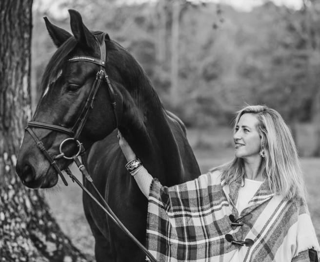 Woman smiling at her horse